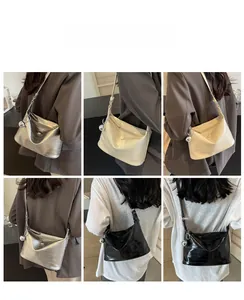 Collage of crocodile pattern crossbody bags in silver, cream, and black with metal charms