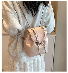 Detail of pink leather backpack with silver chain straps and metallic turn-lock closure