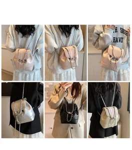 Detail view of fashion chain backpack in four colors with metal buckle and woven straps