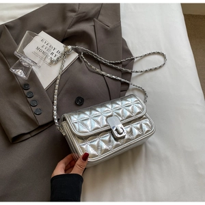 Detail of silver quilted leather bag with metallic twist lock and chain strap