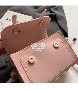 Detailed view of pink crossbody bag featuring magnetic snap closure and internal compartment