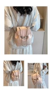 Close-up of light pink leather backpack with silver metal buckle and chain straps