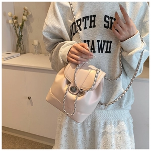 Detail view of pink mini chain bucket bag with silver twist lock and leather strap
