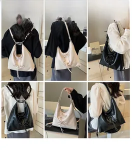 Detail showing versatile straps with metal chains and leather on a large tote bag