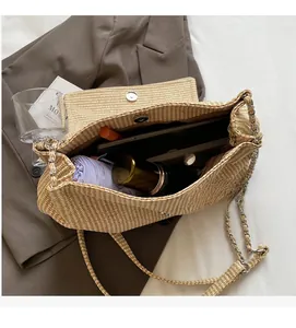 Spacious interior of beige woven bag showing a purple umbrella and makeup essentials