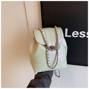 Macro shot of mint green pearlescent bucket backpack with chain strap and metal lock