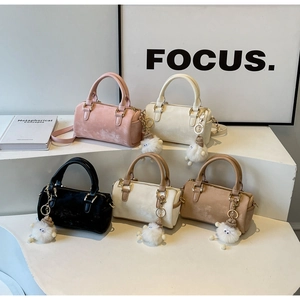 Boston bags in five colors with matte texture and fuzzy monster charms on display