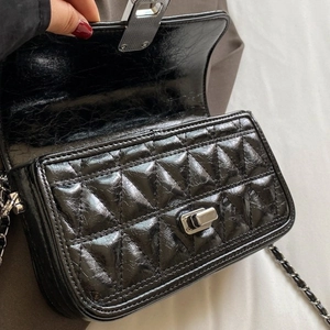 Black quilted rhombic chain bag with silver twist lock and polished finish