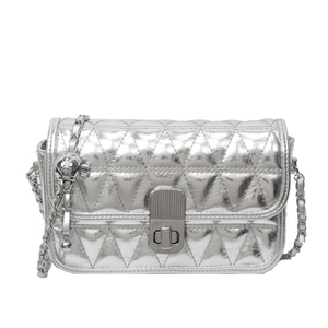 Silver quilted chain bag with triangular texture and metallic ball detail in minimalist style