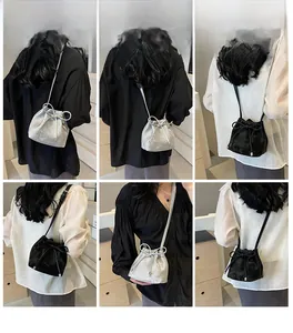 Vues détaillées du mini sac seau à cordon avec nœud en finitions argentée et noire