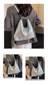 Detail of silver metallic hobo bag featuring lace-up bow and versatile chain strap