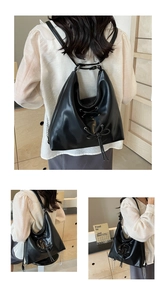 Detail view of black leather Hobo bag featuring cross-laced eyelets and ribbon bow design