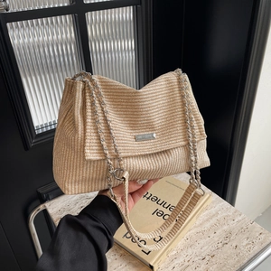Minimalist beige woven chain shoulder bag for women shown in a modern lifestyle setting