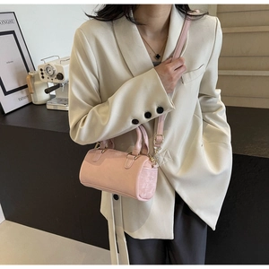 Detail view of mini pink Boston bag with premium leather texture and gold hardware details