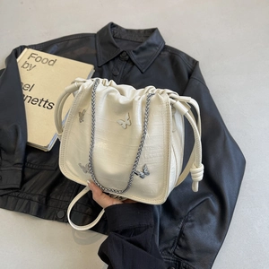 Chic cream white pleated drawstring bag with silver metal butterflies and chain strap