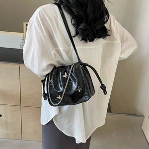 French style black crocodile pattern bucket bag with silver butterfly charms on shoulder