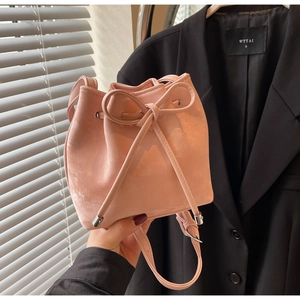 Gros plan détaillé du sac seau rose avec cordon de serrage et grand nœud décoratif