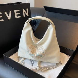 Embroidered cream hobo bag with floral patterns and silver chain in a luxury gift box