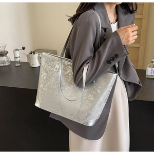 Silver metallic textured tote bag with cracked finish and dual strap system for women