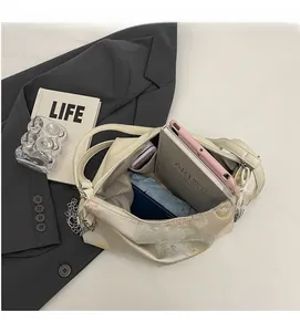Interior view of off-white floral bag showing space for phone and folding umbrella
