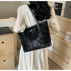 Chic black tote bag in vintage marble texture leather shown on model for daily commuting