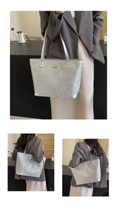 Detail of silver metallic tote bag with ice-crack texture and reinforced corners