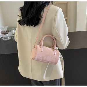 Detail of pink velvet Boston bag showing fine pearlescent texture and gold zipper hardware