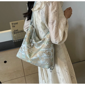 Detailed view of Chinese style embroidery tote bag with silk texture and chain strap