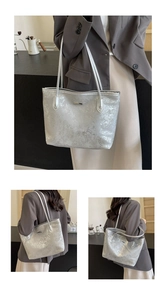 Close-up of the silver metallic crackle texture and dual handle design on a large tote bag