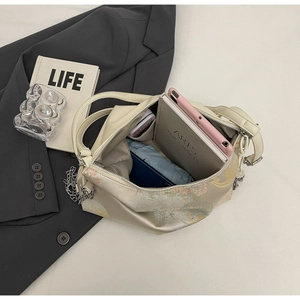 Top view showing the large capacity interior and floral print of the cream tote bag
