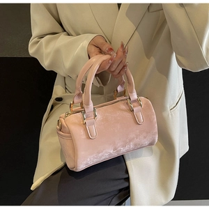 Detailed macro view of pink Boston barrel bag texture and gold hardware details