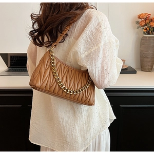 Vue détaillée du sac plissé caramel avec chaîne dorée et texture douce et froissée