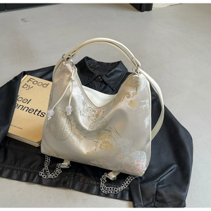 Detail of New Chinese style embroidered silk bag with floral patterns on leather jacket