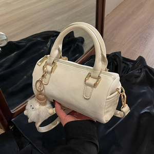 Elegant cream Boston bag with cute furry charm, small cylindrical shoulder bag for women