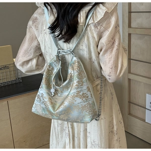 Detailed embroidery on mint green jacquard bag with elegant landscape patterns and beads
