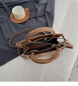 Detail view of brown tote bag showing multi-compartment interior for organized storage