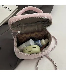 Top view of pink quilted handbag showing interior liner and essential storage space