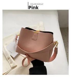 Detail of pink lychee pattern bucket bag with golden hardware and stylish wide strap
