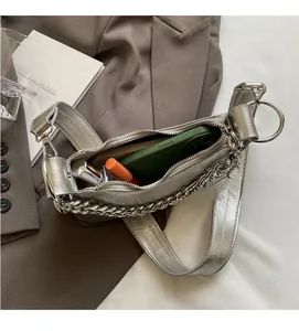 Detail view of the spacious interior of the silver shoulder bag with wide strap