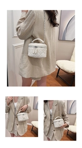 Detailed views of a white quilted crossbody vanity bag with top handle and chain strap