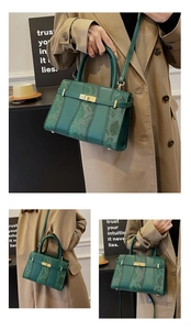 Detailed macro view of green snakeskin texture and metallic gold twist lock on handbag