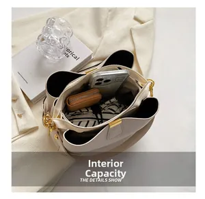 Detailed interior of a beige leather handbag showing large storage capacity for items