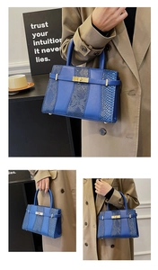 Detail of blue snake pattern patchwork handbag with gold clasp and protective feet