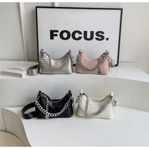 Detailed view of crocodile pattern underarm bags in four colors with silver metal chains