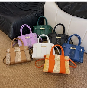 Detailed collection of seven textured faux snakeskin satchels with gold metal locks