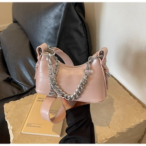 Pink croc-embossed crescent underarm bag featuring a chunky silver metal chain strap