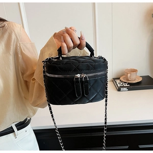 Quilted black leather handbag featuring dual zippers and a silver chain strap for shoulder wear
