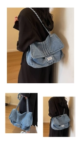 Detail view of washed denim tote bag with silver chain strap and metal swivel lock