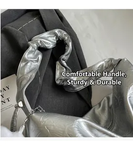 Detail of silver metallic tote bag featuring wide pleated handle and crinkled texture