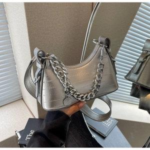 Detail of silver metallic hobo bag featuring animal embossed texture and chunky chain